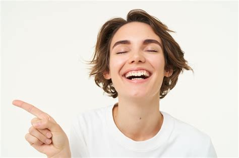 Free Photo Close Up Portrait Of Brunette Girl With Happy Face Laughing Pointing Finger Left