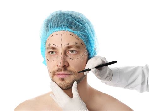 Doctor Drawing Marks On Man`s Face For Cosmetic Surgery Operation