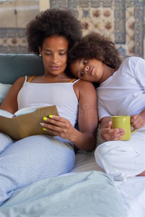 Caring African American Mother Reading To Daughter In Bed Stock Image Image Of Cozy Girl