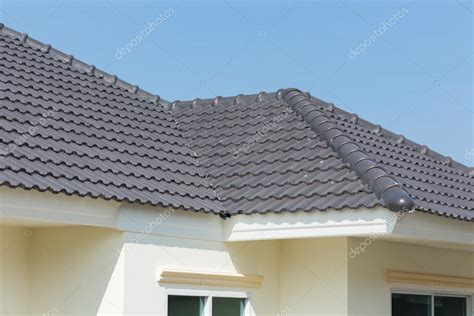 Black Roof Tiles On House With Blue Sky — Stock Photo © Sutichak 72497663