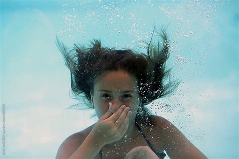 A Girl Holding Her Breath While Swimming Underwater By Alicia Bock Stocksy United