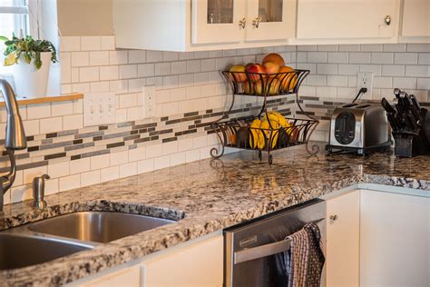This subtle backsplash gets its oomph from textured tiles in various shapes and sizes. Kitchen Granite Image Galleries for Inspiration