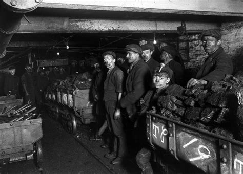 Black And White Photograph Of Men In An Industrial Area