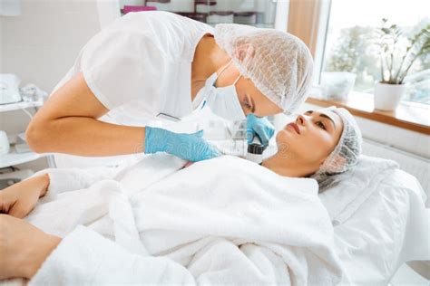 Skilled Female Dermatologist Doing The Skin Examination Stock Photo