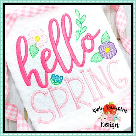 The Hello Spring Applique Is On Top Of A Pink And White Checkered Table