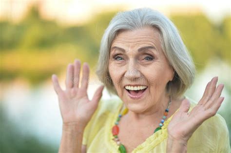 Close Up Portrait Of Smiling Surprised Senior Beautiful Woman Posing