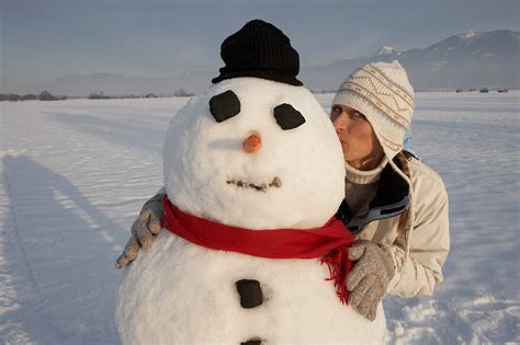 Woman Kissing Snowman License Image 70046382 Image Professionals