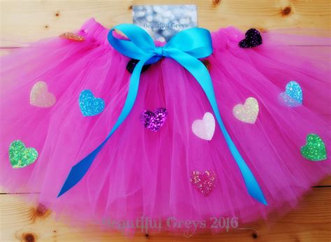 A Pink Tutu With Hearts On It And A Blue Ribbon Around The Waist