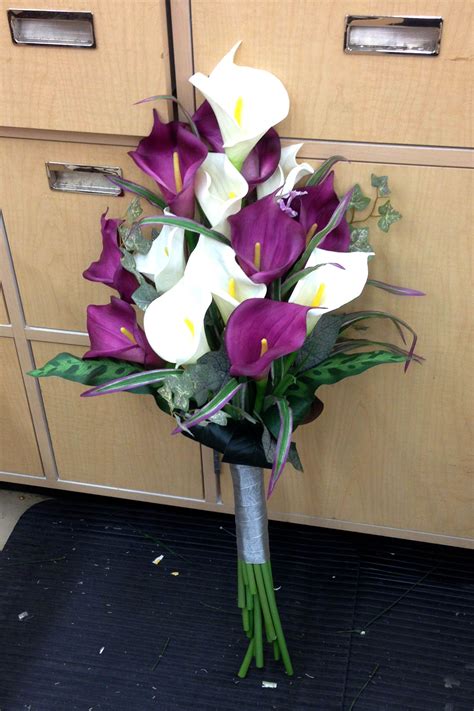 Known for their vibrance, fragrance, and versatility, lilies are a popular choice for flower arrangements, no matter the occasion. white and purple calla lily brides pageant style bouquet ...