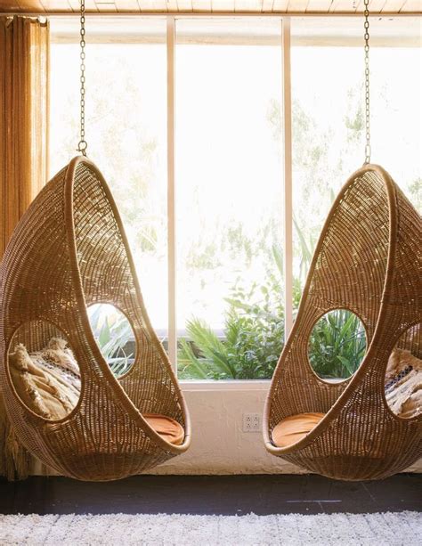 Two Hanging Chairs In Front Of A Window