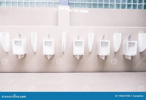 Men`s Toilet Public With White Porcelain Urinals Stall Modern Clean
