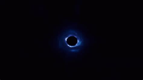 A Black Hole In The Dark With Blue Light Coming From It S Center And Inside
