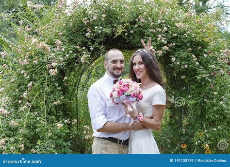 Lovers Newlyweds Beautiful Couple In Love Loving Couple In The Garden Among The Flowers Just