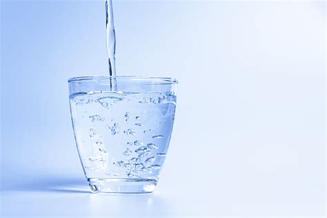 Pouring water in to a glass. Pouring Water Into A Glass Stock Photo - Download Image ...