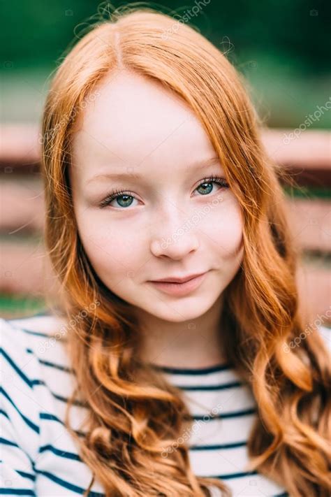 Close Up Portrait Of Pretty Smiling Girl With Long Curly Red Hair In