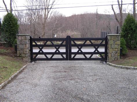 A Transitional Or Updated Farmhouse Wooden Driveway Gate Welded Wire