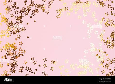 Border Frame Made Of Gold Colored Stars Confetti On A Pink Pastel
