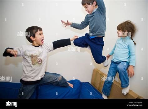 Male Children Play Fighting On The Sofa Stock Photo Alamy