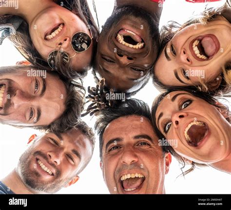 Young People Looking Down At Camera And Laughing Multiracial Group Of