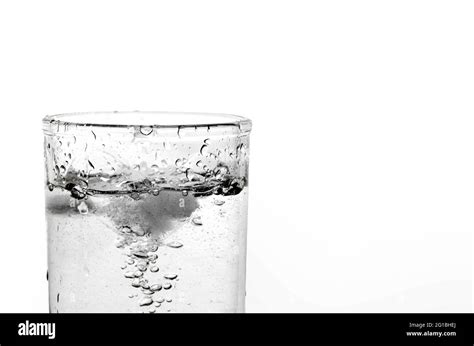 A Glass Of Water And Ice On A White Background Close Up Of Air Bubbles In Mineral Water Stock