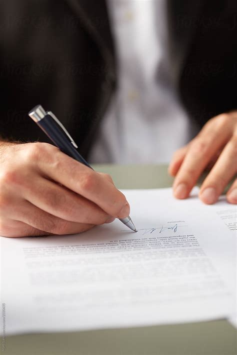 Closeup Of Man Signing Paper By Stocksy Contributor Martí Sans