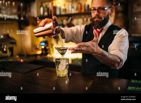 Barman Flaring Behind Bar Counter Restaurant Shelves With Alcoholic