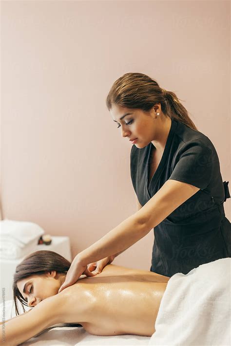 Woman Enjoying A Back Massage By Stocksy Contributor Victor Torres