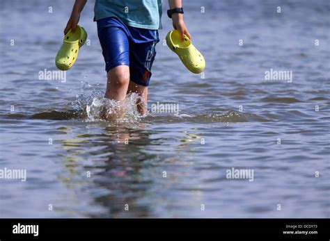 People Wade Through The Water From The Ferry Ms Salzhaff To Reach The