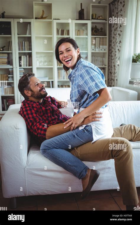 Happy Woman Sitting On Mans Lap In Living Room Stock Photo Alamy