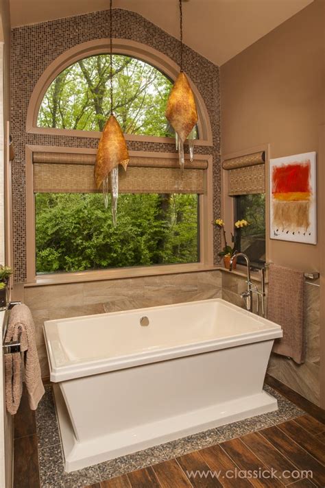 Why is it called a garden tub?. Free standing tub sitting on pebble / river rock tile to ...