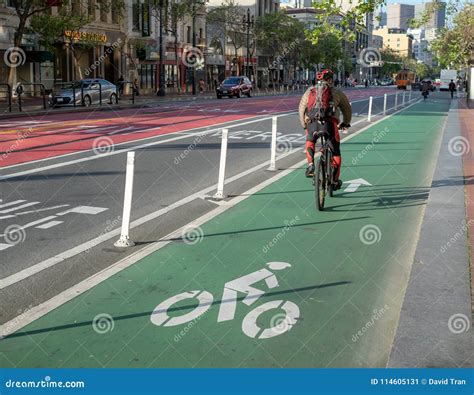 Cyclist Uses A Designated Bike Lane On Market Street On Commute