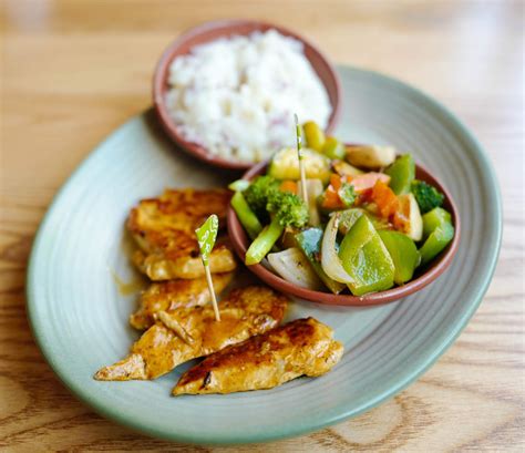 Grilled chicken tenders with spicy rice, spinach, corn and red pepper. Eat Drink KL