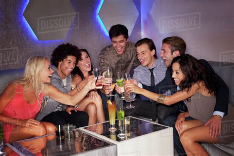 Friends Toasting Cocktails In Nightclub Stock Photo Dissolve