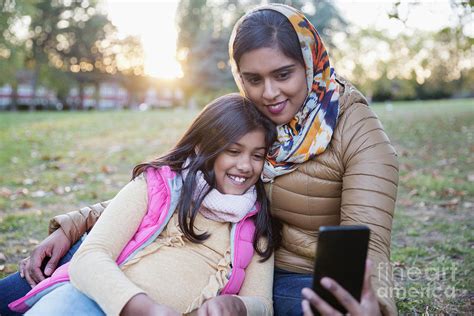 Muslim Mother In Hijab Taking Selfie With Daughter Photograph By Caia