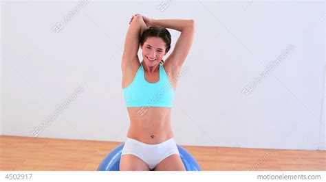 Fit Brunette Stretching On An Exercise Ball Stock Video Footage 4502917