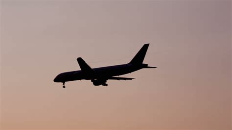 Airplane Flying In Sky Silhouette Of Jet Plane Descending Preparing
