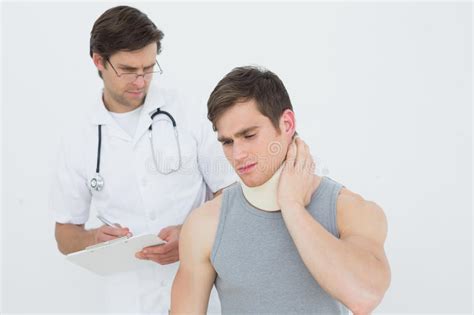 Male Doctor Examining A Patients Neck Stock Image Image Of Standing