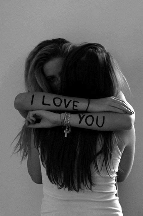 two women hugging each other with the words i love you written on their arms behind them