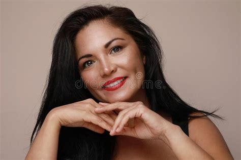 Mature Hispanic Woman With Red Lips Posing And Smiling Over White Background Stock Image