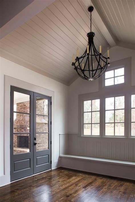 Gray Cottage Mudroom Features A Gray Shiplap Vaulted Ceiling Accented