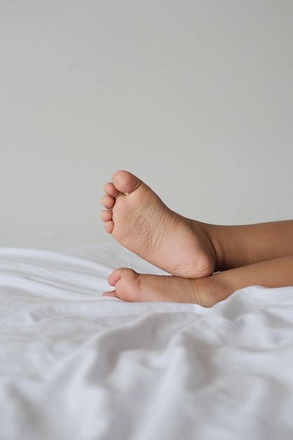 Premium Photo Children39s Bare Feet On White Bed