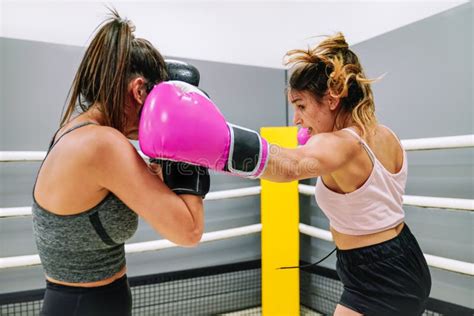 Two Female Boxers Practicing Boxing In The Ring At The Gym Stock Image