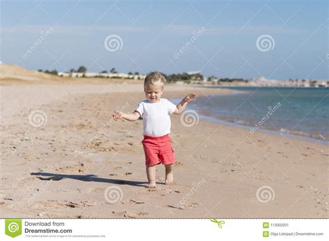 Small Baby Boy Walking The Seaside Concept For Travel Ad Stock Image