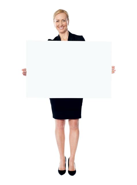 A Woman In Business Attire Holding Up A White Sign