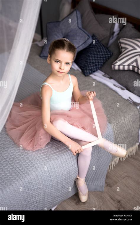 Cute Little Ballerina In Pink Ballet Costume And Pointe Shoes Is
