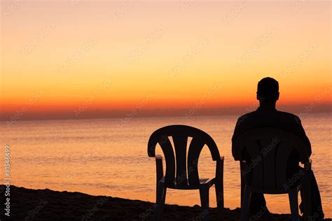 Man Sits On Chair Alone In Sunset Stock Photo Adobe Stock