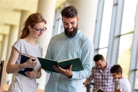 Happy Group Of Students Studying And Working Together In A College