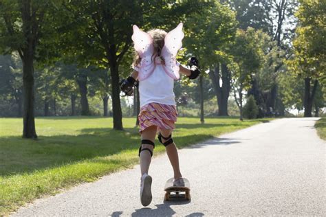 Young Girl Skateboarding While Wearing Fairy Wingswhitby Ontario