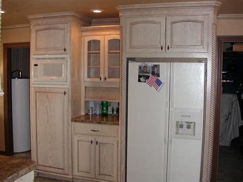 I used two coats of annie sloan's chalk paint, white washed ( paint thinned with water) with an off white paint, distressed and clear coated with a poly top. Pickled oak kitchen cabinets photos