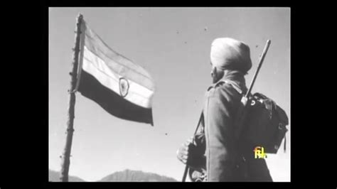 Indian Soldier Stands Guard By The Indian Flag At Haji Pir Pass After